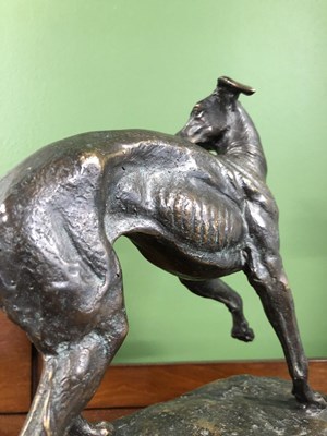 Lot 39 - Style of P J Mene, a bronze whippet poised on...