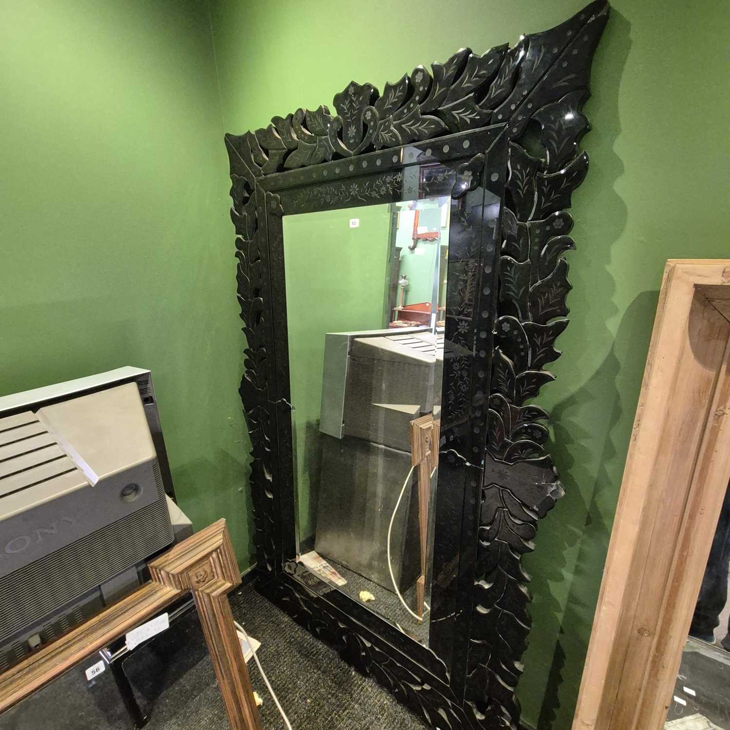 Lot 53 - A bevelled glass rectangular mirror within a...