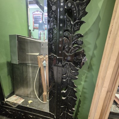 Lot 53 - A bevelled glass rectangular mirror within a...