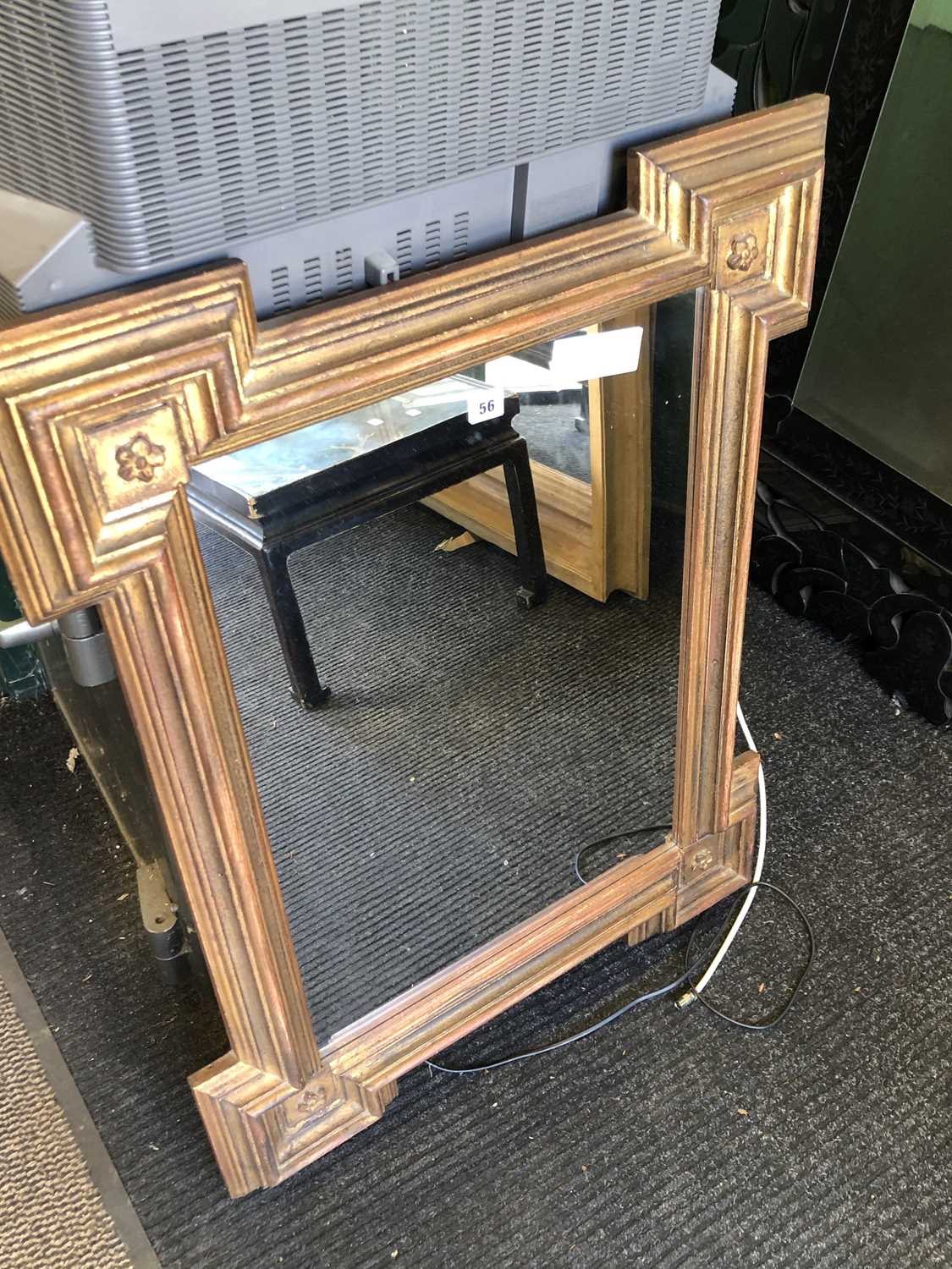 Lot 56 - A rectangular mirror in a gilt frame with...
