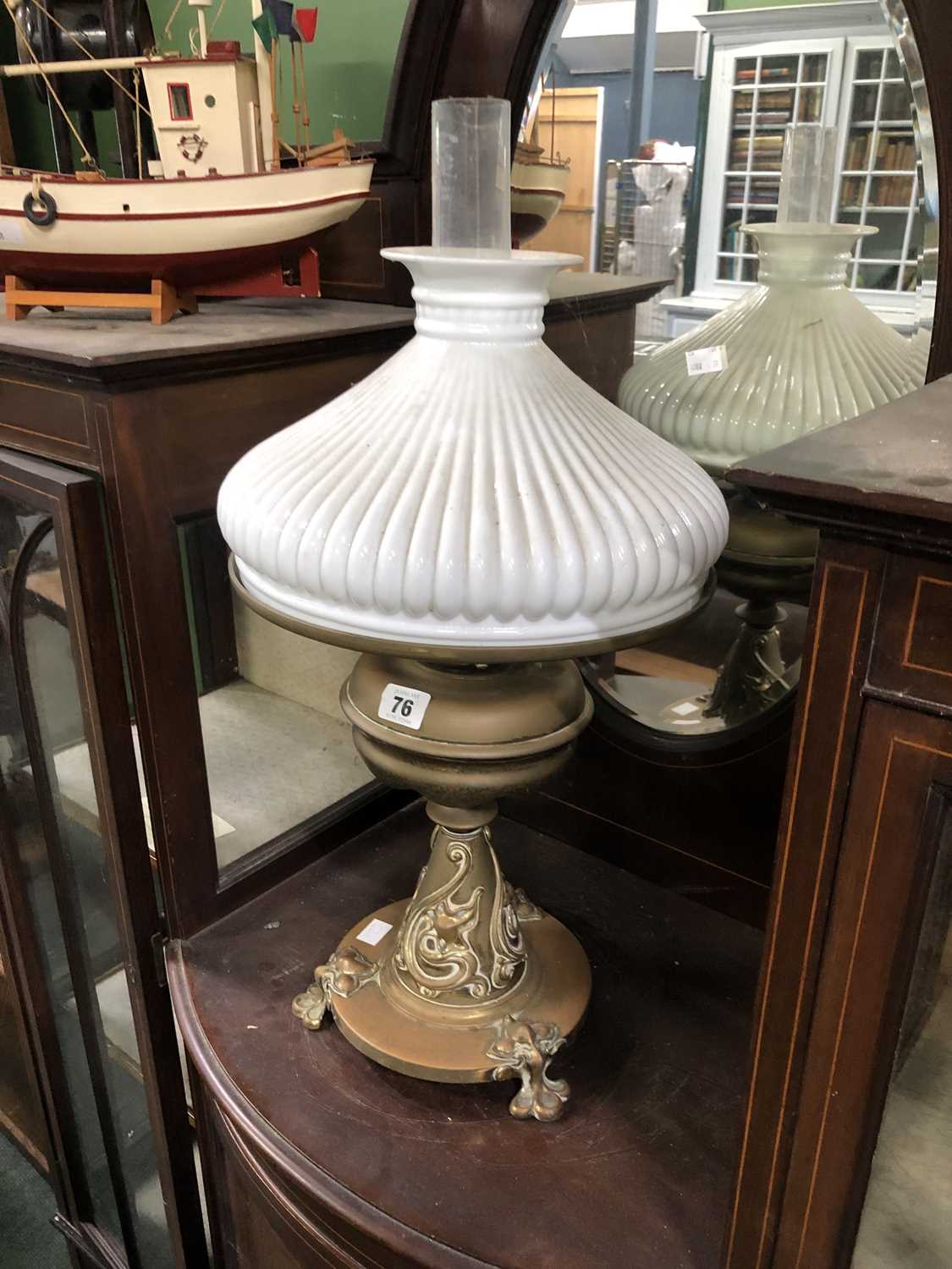 Lot 76 - An Art Nouveau brass oil lamp with a milk...