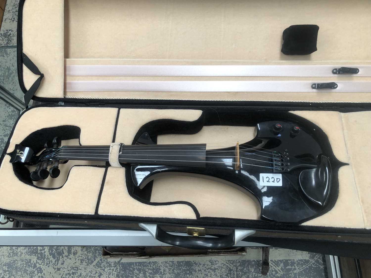 Lot 1220 - A cased electric violin