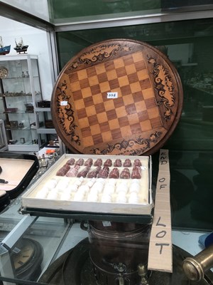 Lot 1228 - A white and brown stone chess set together...