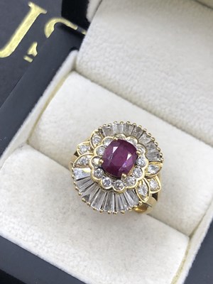 Lot 510 - A ruby and diamond ballerina ring. The central...