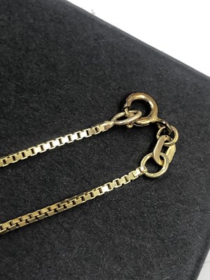Lot 516 - A boxlink pendant chain. Unhallmarked, stamped...