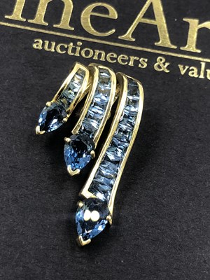 Lot 519 - A contemporary blue gemset triple cascade...