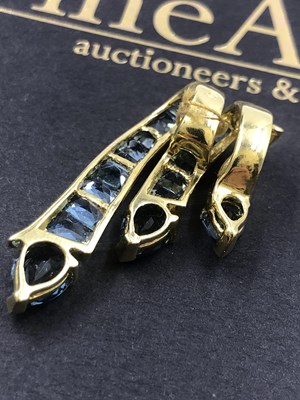 Lot 519 - A contemporary blue gemset triple cascade...