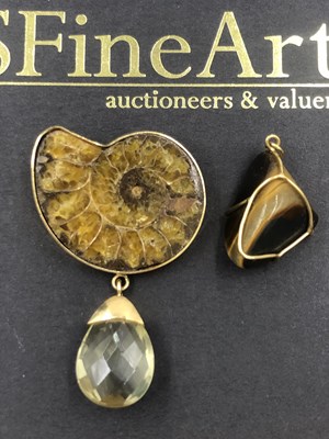 Lot 532 - An ammonite fossil section mounted as a brooch...