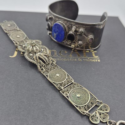 Lot 537 - A gemset wide cuff bangle and a filigree panel...