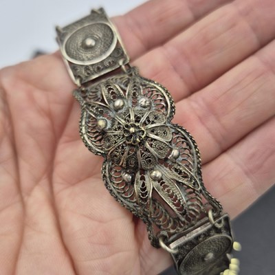 Lot 537 - A gemset wide cuff bangle and a filigree panel...