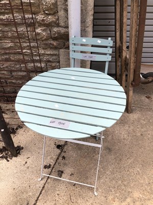 Lot 1305 - A small patio table and a single chair.