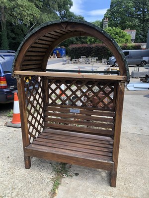 Lot 1308 - A canopied garden seat with trellis sides.