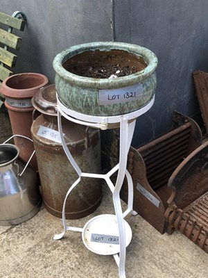Lot 1321 - A wrought iron stand with pottery planter.