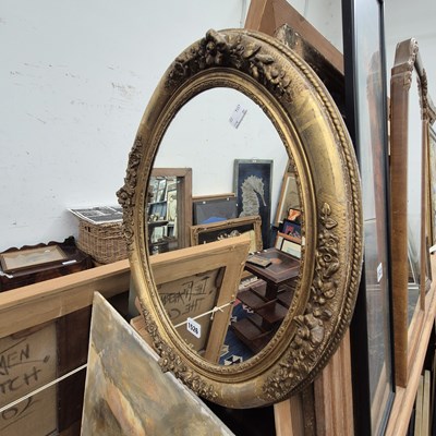 Lot 1526 - An antique oval wall mirror.