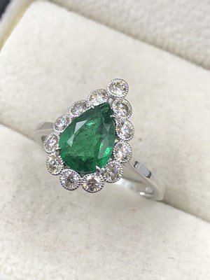 Lot 520c - An emerald and diamond ring. The central...