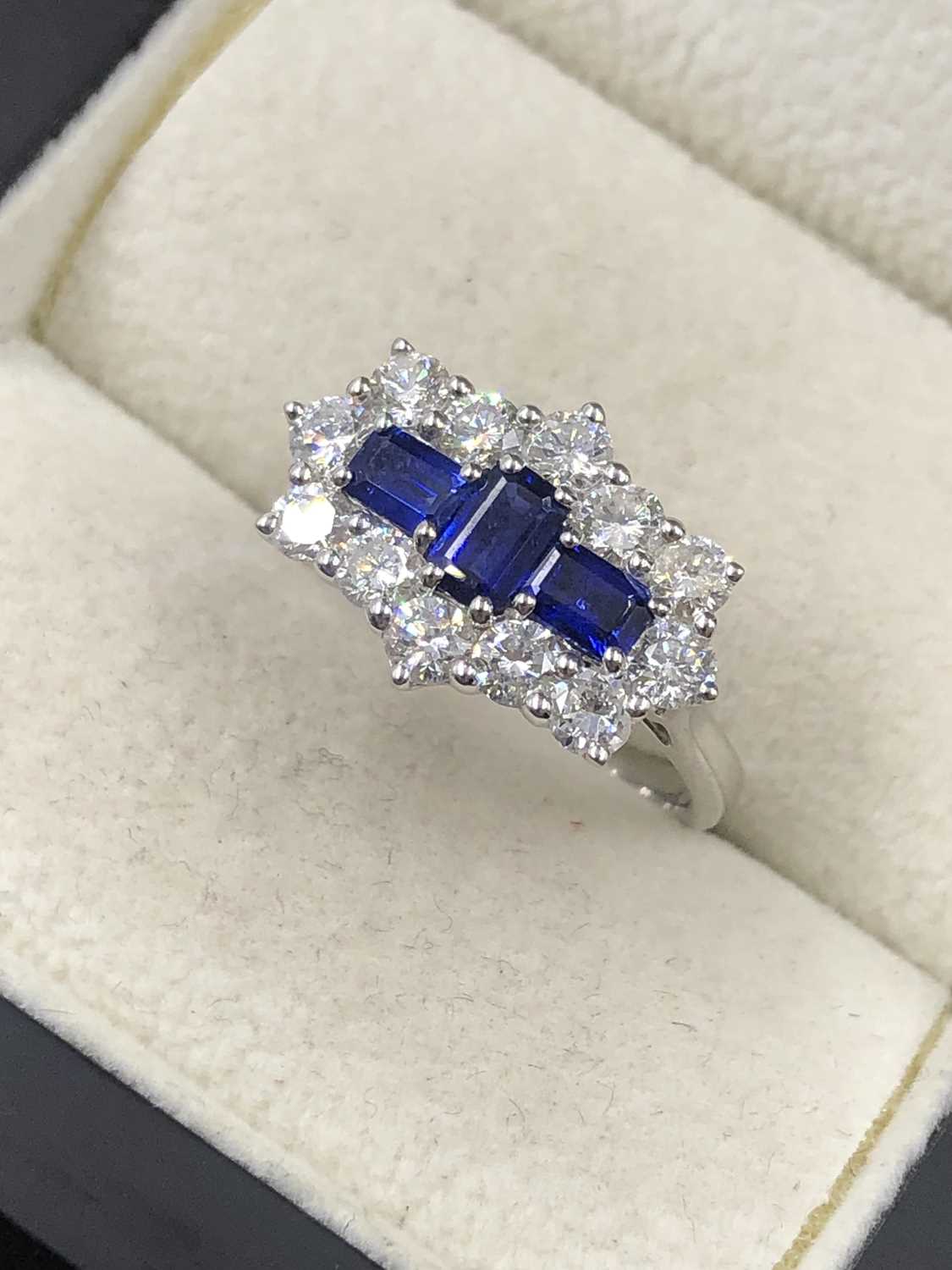 Lot 540 - A hallmarked platinum, sapphire and diamond...