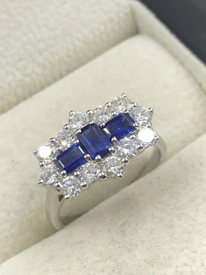 Lot 540 - A hallmarked platinum, sapphire and diamond...