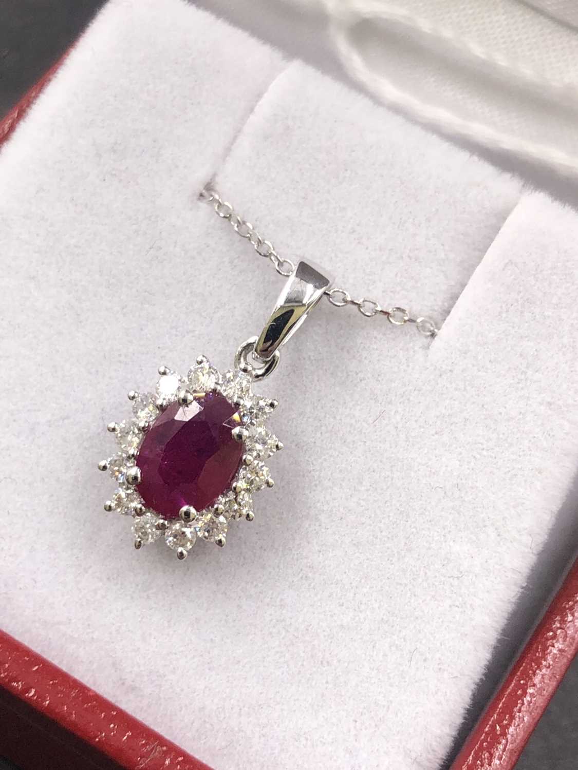 Lot 545 - An 18ct hallmarked white gold oval ruby and...