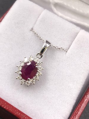 Lot 545a - An 18ct hallmarked white gold oval ruby and...