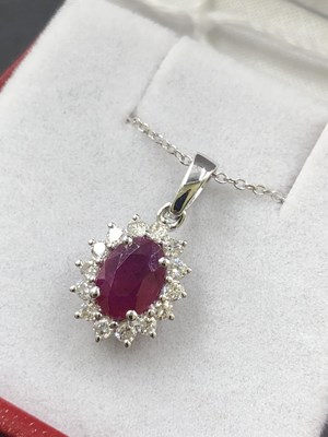 Lot 545 - An 18ct hallmarked white gold oval ruby and...