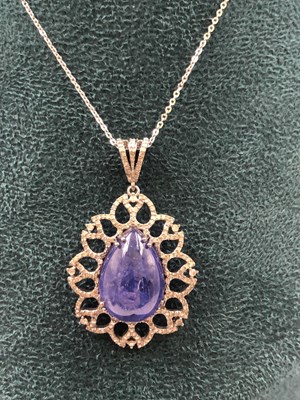 Lot 545b - A pear-shaped cabochon tanzanite and diamond...