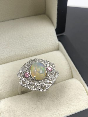 Lot 545c - An ornate dress ring set with a cabochon opal,...
