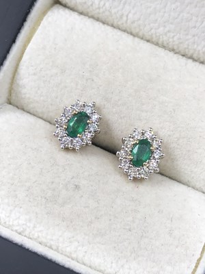 Lot 555c - A pair of oval emerald and round brilliant cut...