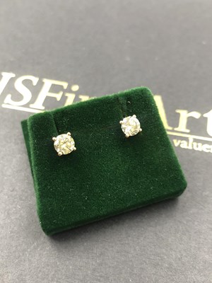 Lot 565a - A pair of rose gold 4 claw-set round brilliant...