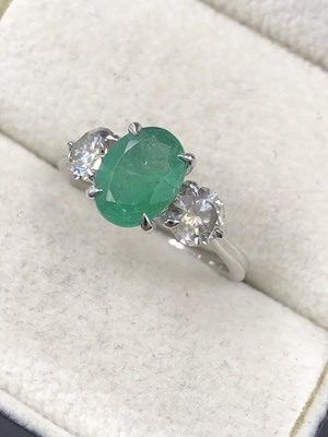 Lot 565b - A  hallmarked platinum oval emerald and round...