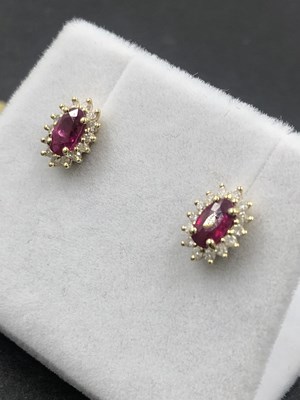 Lot 570a - A pair of hallmarked 9ct yellow gold oval ruby...