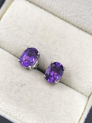Lot 570c - A pair of amethyst studs in silver, unhallmarked.