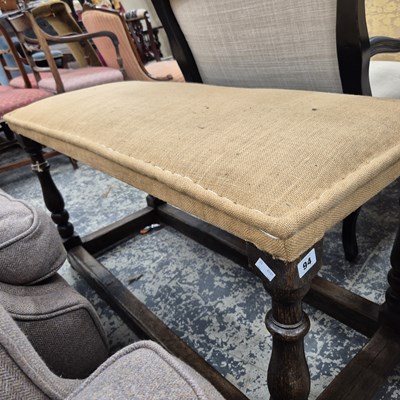 Lot 94 - A large oak framed long stool.