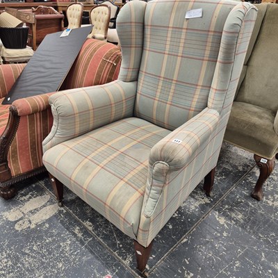 Lot 117 - A wing back armchair.
