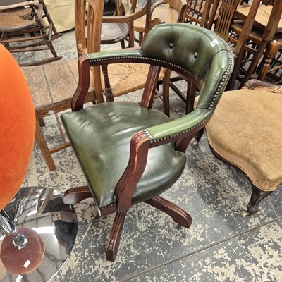 Lot 123 - A green upholstered swivel office chair.