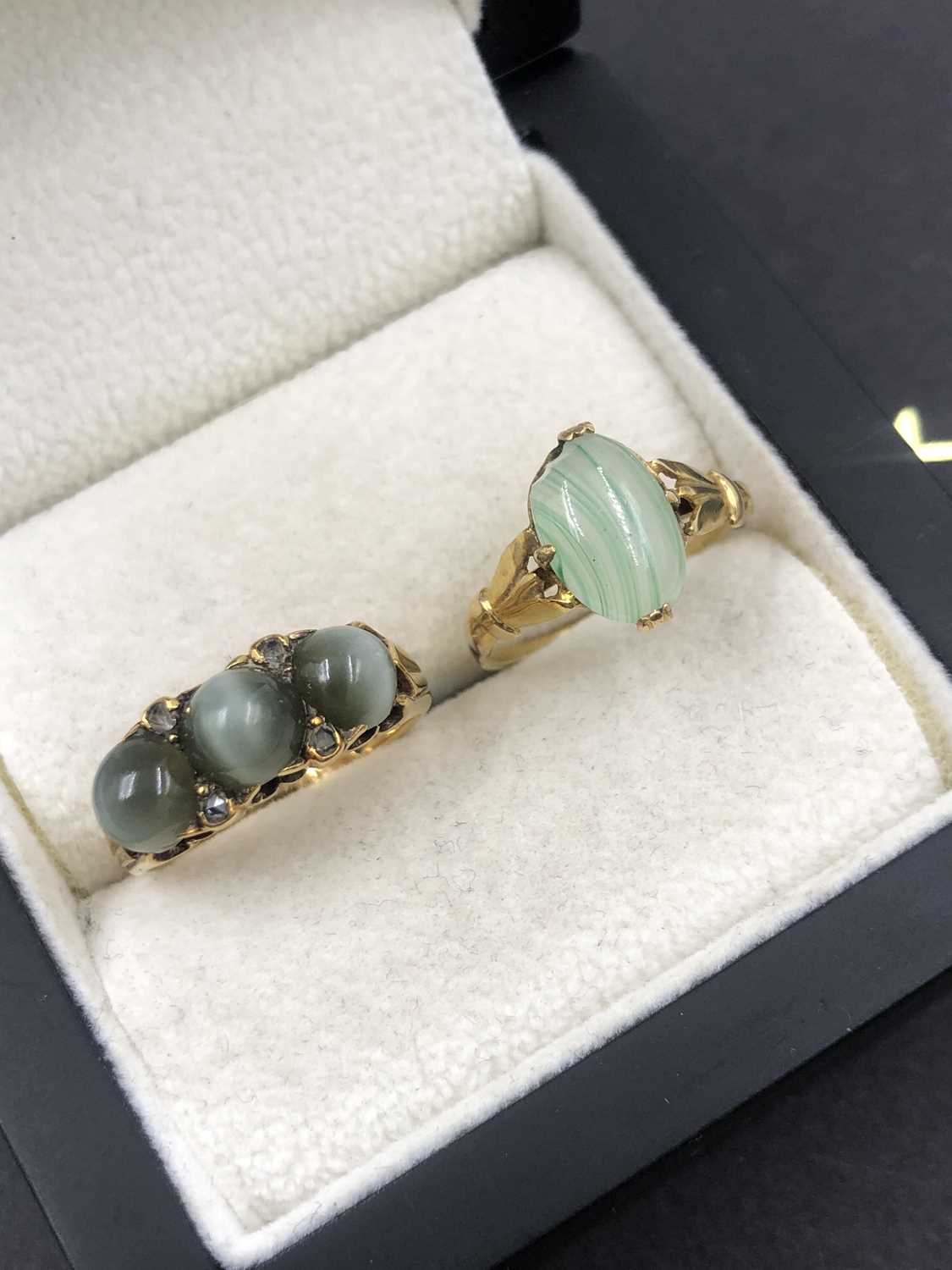 Lot 546 - A three-stone cabochon and diamond set ring,...