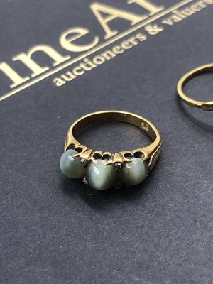 Lot 546 - A three-stone cabochon and diamond set ring,...