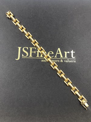 Lot 548 - A fancy link bracelet, stamped 750, assessed...