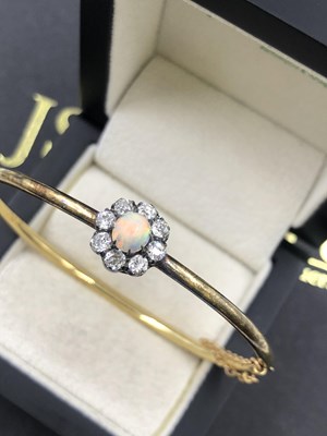 Lot 558 - An antique opal and diamond cluster set hinged...