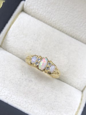Lot 571 - A vintage opal and old-cut diamond half hoop...