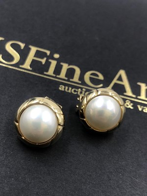 Lot 624 - A pair of made pearl stud earrings with safety...