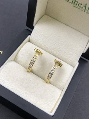 Lot 628 - A pair of 18ct hallmarked gold diamond channel...