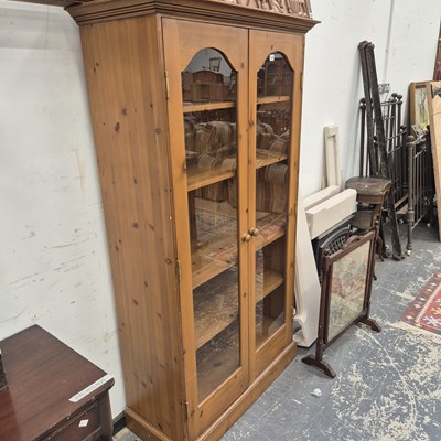 Lot 135 - A glazed pine cabinet.