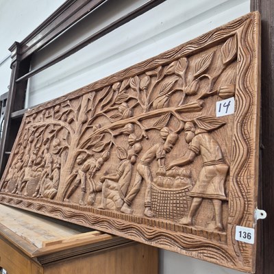 Lot 136 - An eastern carved hardwood panel.