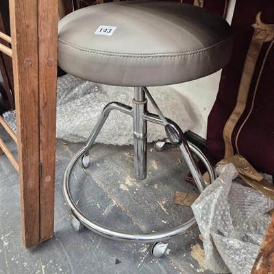 Lot 143 - An office stool.