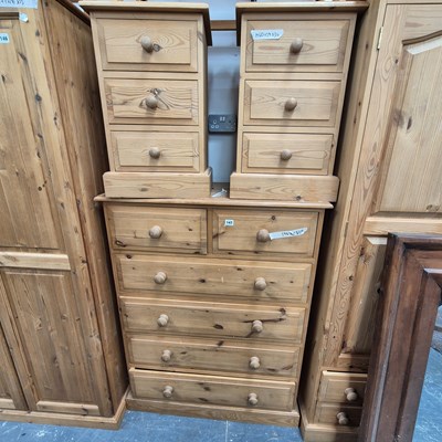Lot 147 - A pine chest of drawers and two bedside chests.