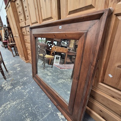 Lot 149 - A large pine-framed wall mirror.
