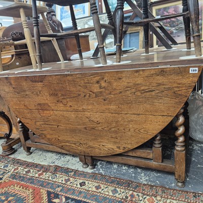 Lot 189 - A large oak drop leaf table with double...