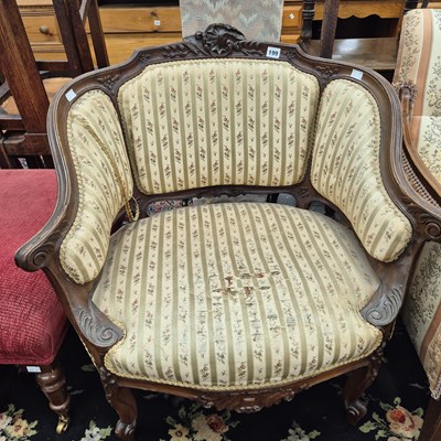 Lot 199 - An antique french show frame salon tub armchair.