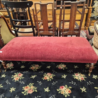 Lot 200 - A large stool on turned legs with brass castors.