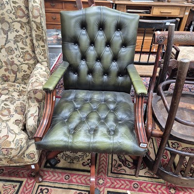 Lot 202 - A button leather swivel office armchair.  W 60...